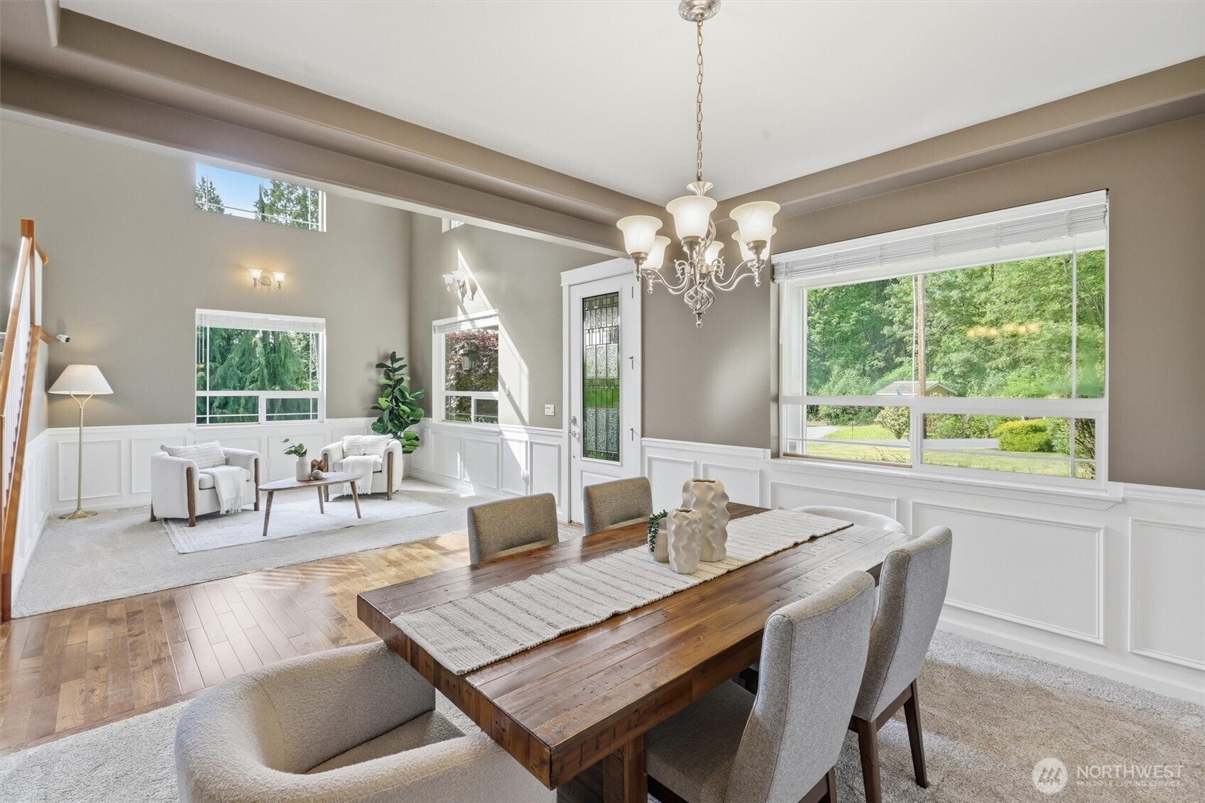 4202 Silvana Terrace Road Stanwood, WA 98292 - Photo 14 of 40 a dining room with wooden floor a chandelier a wooden table and chairs