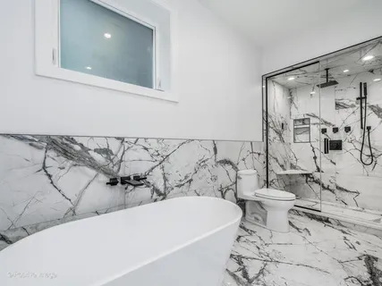 a bathroom with a bathtub and shower