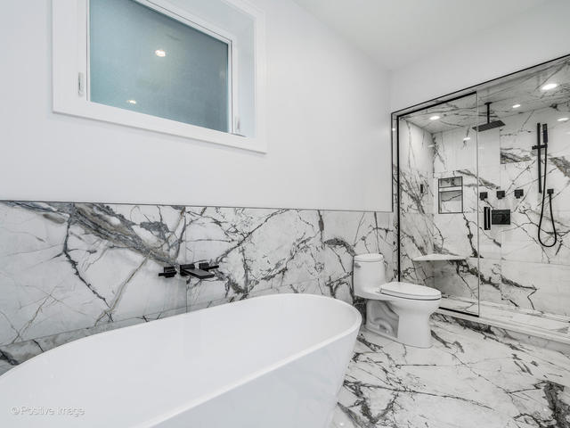 867 North Marshfield Avenue, Unit 1 Chicago, IL 60622 - Photo 12 of 12 a bathroom with a bathtub and shower