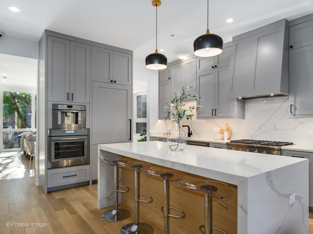867 North Marshfield Avenue, Unit 1 Chicago, IL 60622 - Photo 6 of 12 a kitchen with stainless steel appliances a sink a stove a refrigerator and cabinets