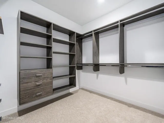 a view of walk in closet with empty racks