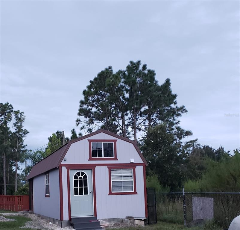 20805 Sheldon Street Orlando, FL 32833 - Photo 16 of 18 a front view of a house with a yard