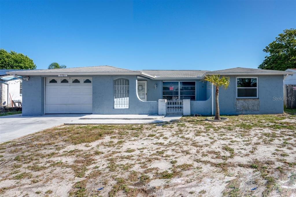 7701 Embassy Boulevard Port Richey, FL 34668 - Photo 1 of 1 a view of a house with a yard
