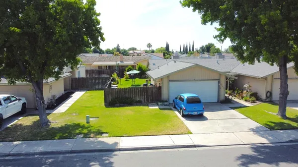 a view of a backyard with plants and patio