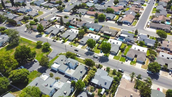an aerial view of residential houses with outdoor space