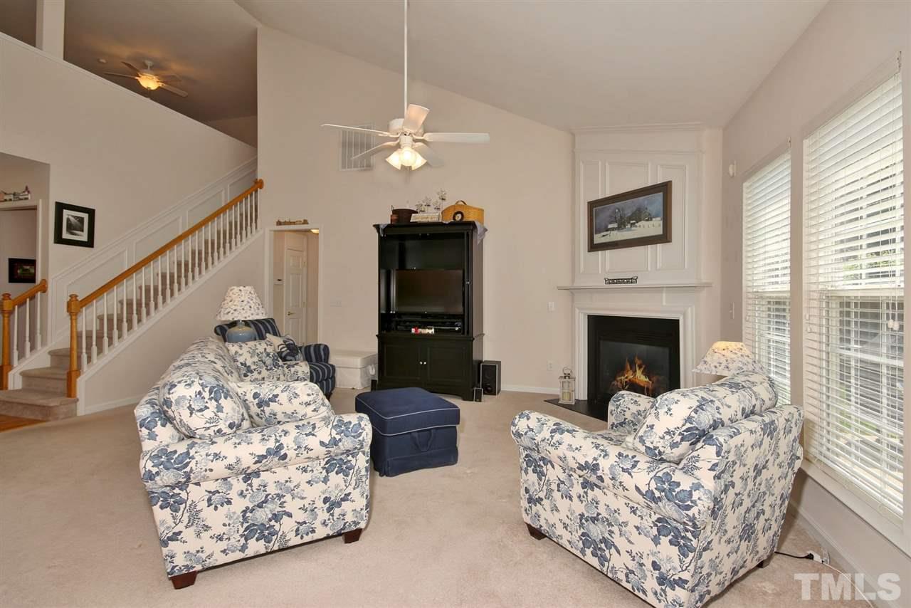 5427 Brandy Bay Road Raleigh, NC 27613 - Photo 6 of 25 Large family room with vaulted ceilings, vast natural lighting and a gas fireplace. Like new carpeting for comfort and a great view of the private backyard.