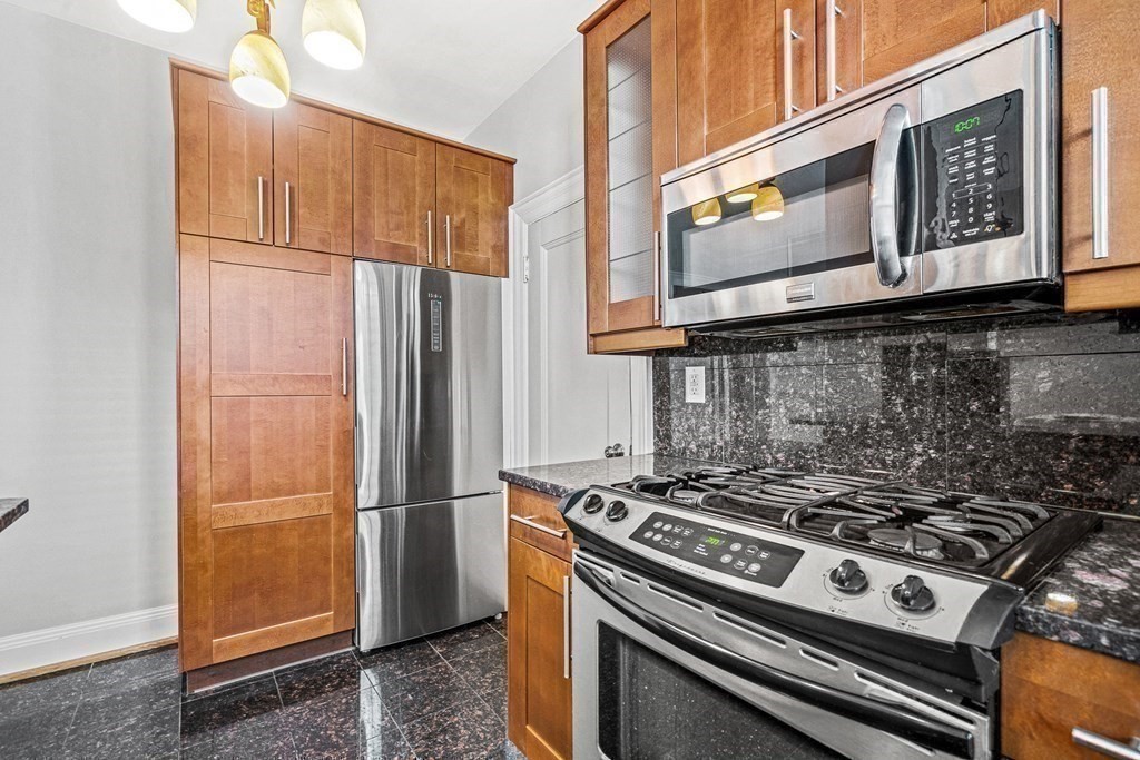 6 Lanark Road, Unit 4 Brookline, MA 02445 - Photo 14 of 23 a kitchen with stainless steel appliances granite countertop a stove and a refrigerator
