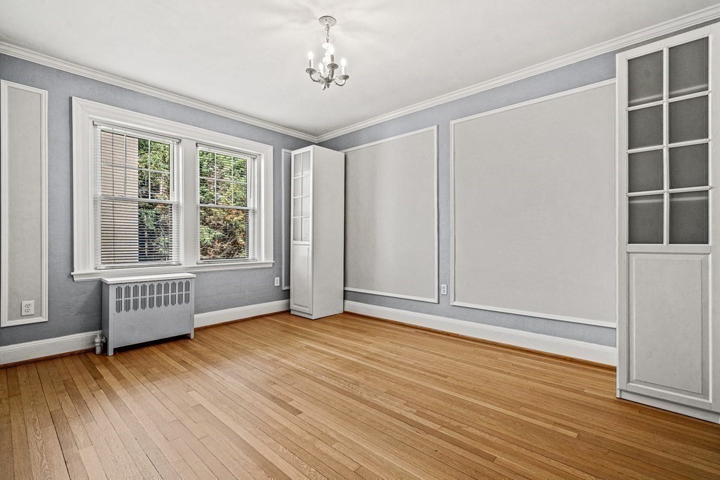 6 Lanark Road, Unit 4 Brookline, MA 02445 - Photo 17 of 23 an empty room with wooden floor and windows