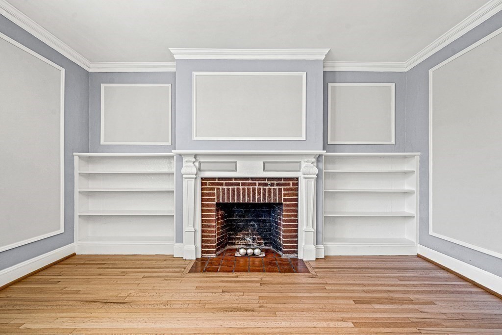 6 Lanark Road, Unit 4 Brookline, MA 02445 - Photo 5 of 23 a view of an empty room with wooden floor fireplace and a window