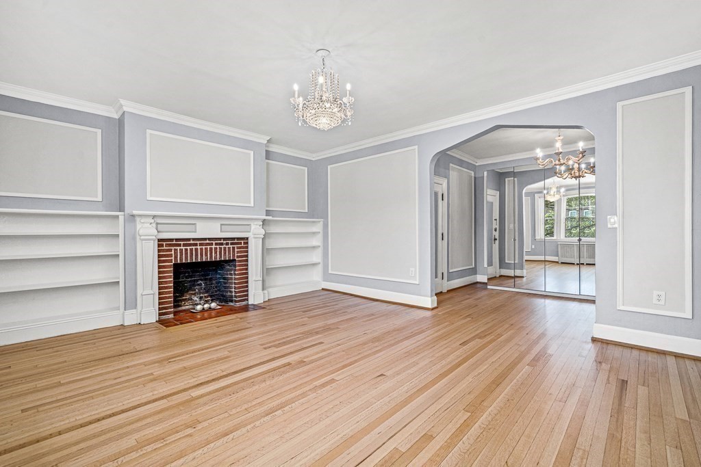 6 Lanark Road, Unit 4 Brookline, MA 02445 - Photo 6 of 23 wooden floor fireplace and windows in an empty room