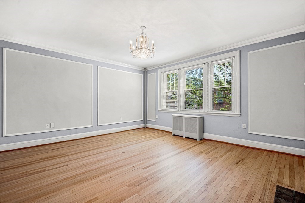 6 Lanark Road, Unit 4 Brookline, MA 02445 - Photo 7 of 23 a view of an empty room with wooden floor and a window