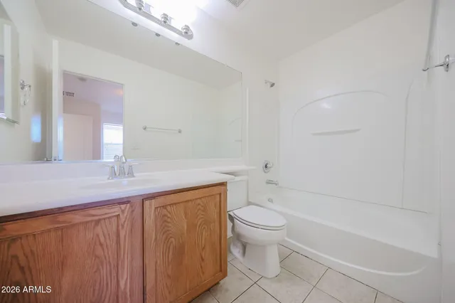 a bathroom with a granite countertop sink a toilet and bathtub