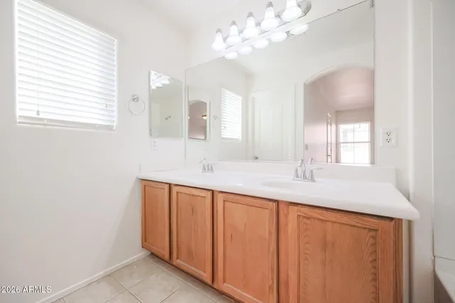 a bathroom with a sink a vanity and a mirror