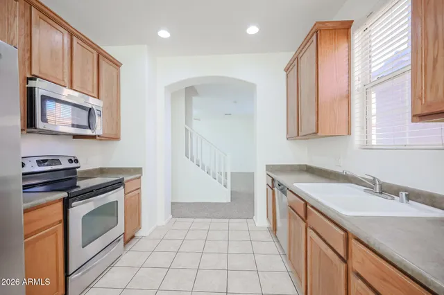 a kitchen with granite countertop a stove sink and cabinets