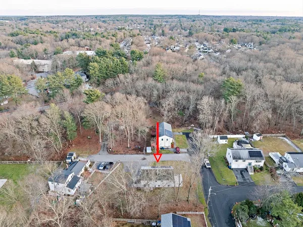 an aerial view of a houses with trees