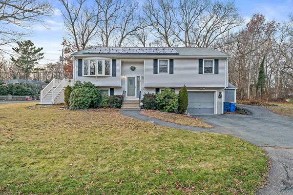 a front view of a house with a yard and garage