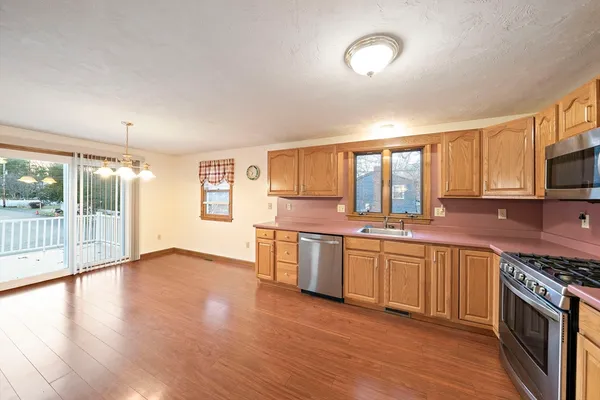 a large kitchen with stainless steel appliances granite countertop a stove and a sink