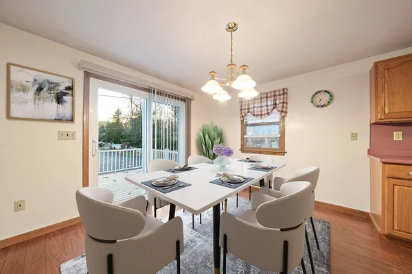 a view of a dining room with furniture wooden floor and chandelier