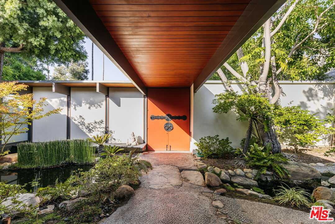 a backyard of a house with flower plants