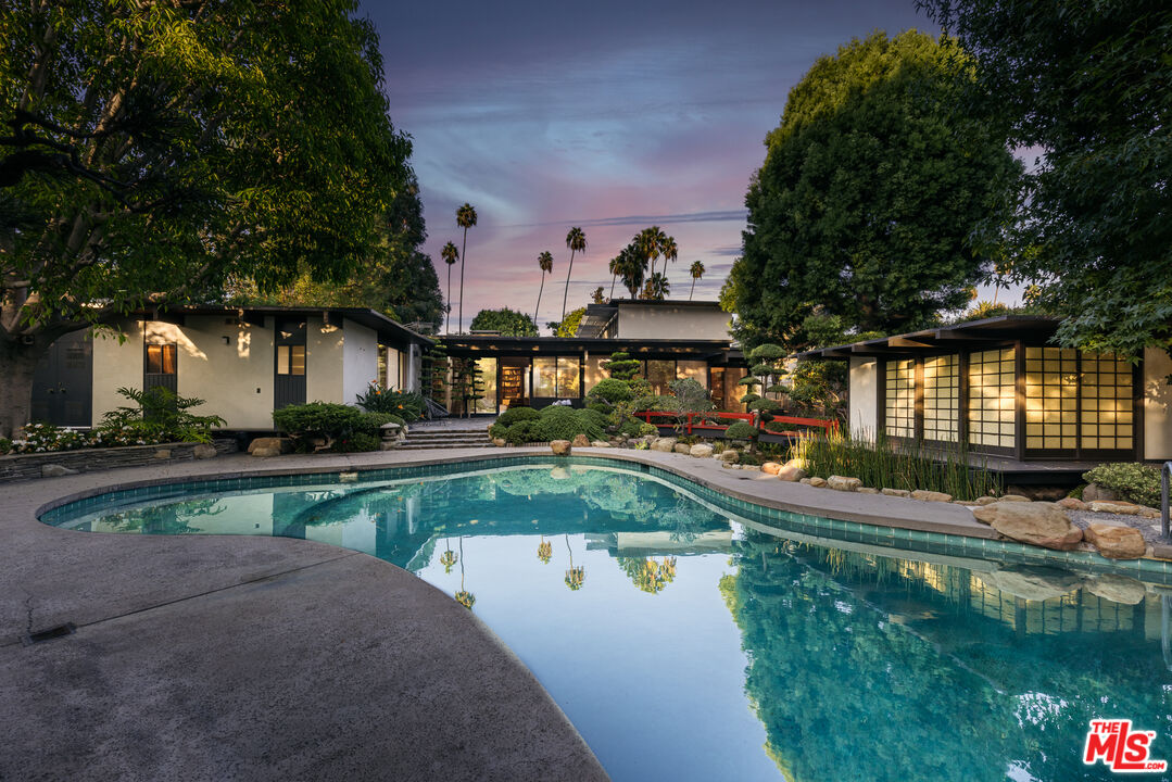 703 North Canon Drive Beverly Hills, CA 90210 - Photo 1 of 44 a view of a swimming pool with a patio