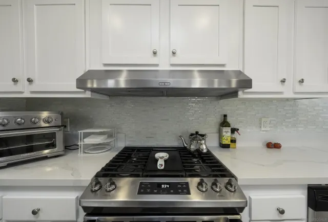 a stove top oven sitting inside of a kitchen