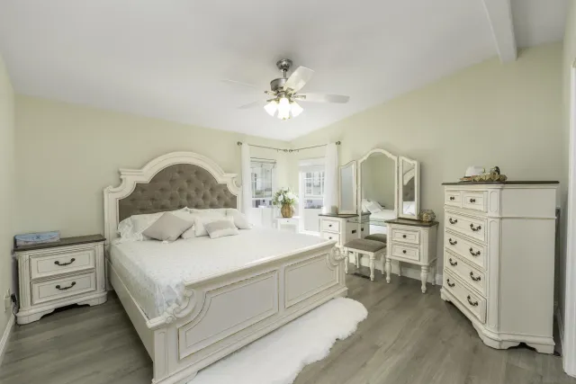 a spacious bedroom with a bed and a chandelier