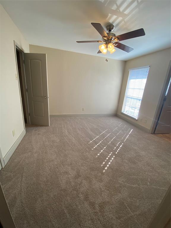 7720 Kings Ridge Road Frisco, TX 75035 - Photo 13 of 16 an empty room with windows and fan