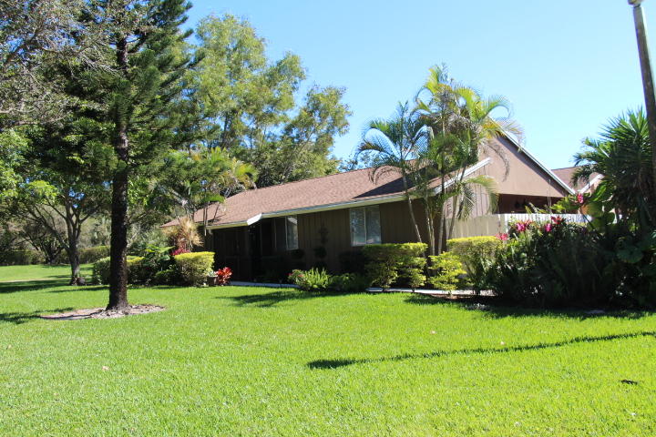 22272 Timberly Drive Boca Raton, FL 33428 - Photo 1 of 7 a front view of house with yard and green space