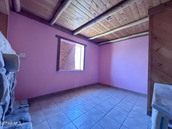 a bedroom with a bed and a chandelier fan