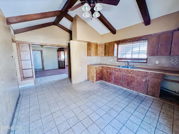 a large kitchen with stainless steel appliances granite countertop a sink and cabinets