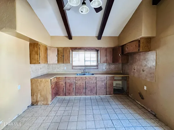 a view of empty room with a fireplace and cabinet