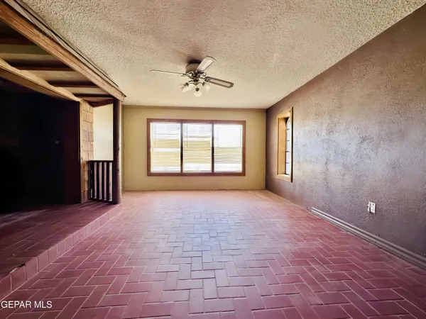 a view of a livingroom with a fireplace and window