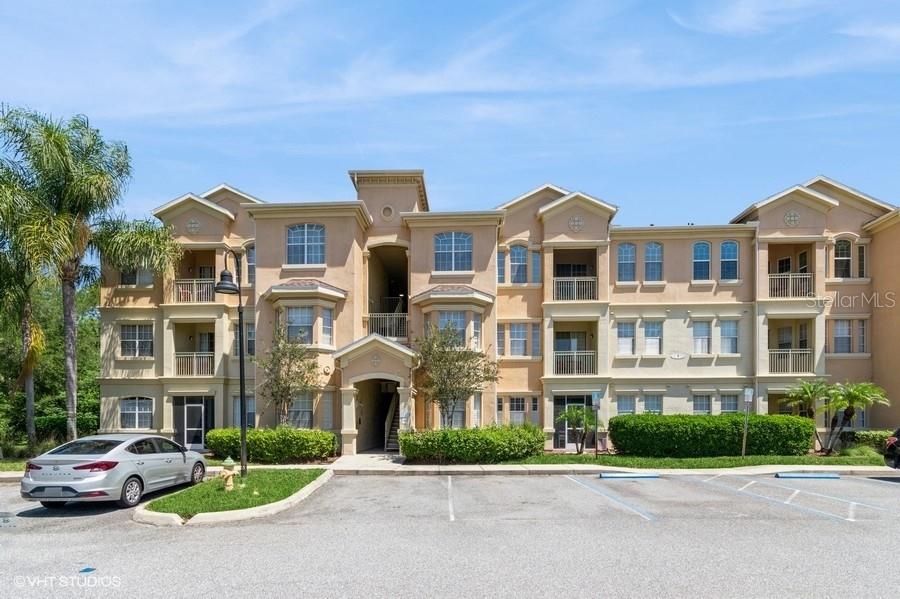 411 Terrace Ridge Circle, Unit 222 Davenport, FL 33896 - Photo 1 of 1 a front view of a residential apartment building with a yard