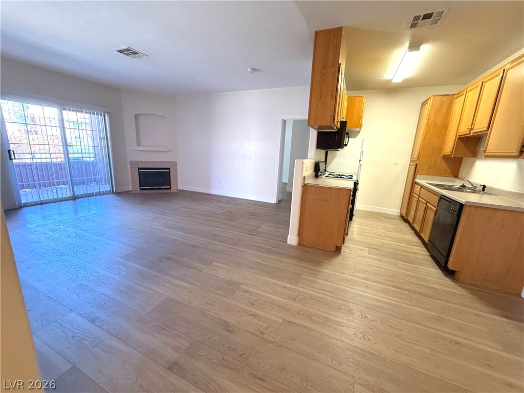 4730 East Craig Road, Unit 1164 Las Vegas, NV 89115 - Photo 3 of 14 An inviting open-concept layout features a cozy fireplace and convenient sliding glass doors.