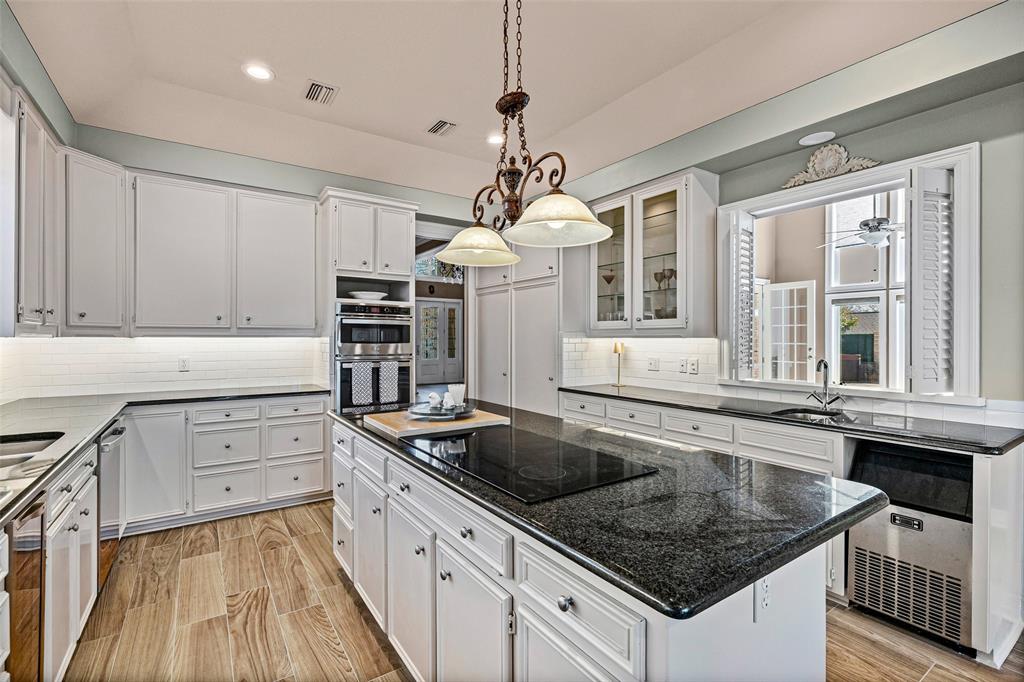 8908 Brierfield Road Granbury, TX 76049 - Photo 12 of 40 a kitchen that has a sink and a stove