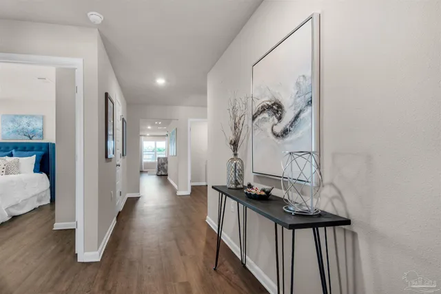 a view of a hallway with wooden floor