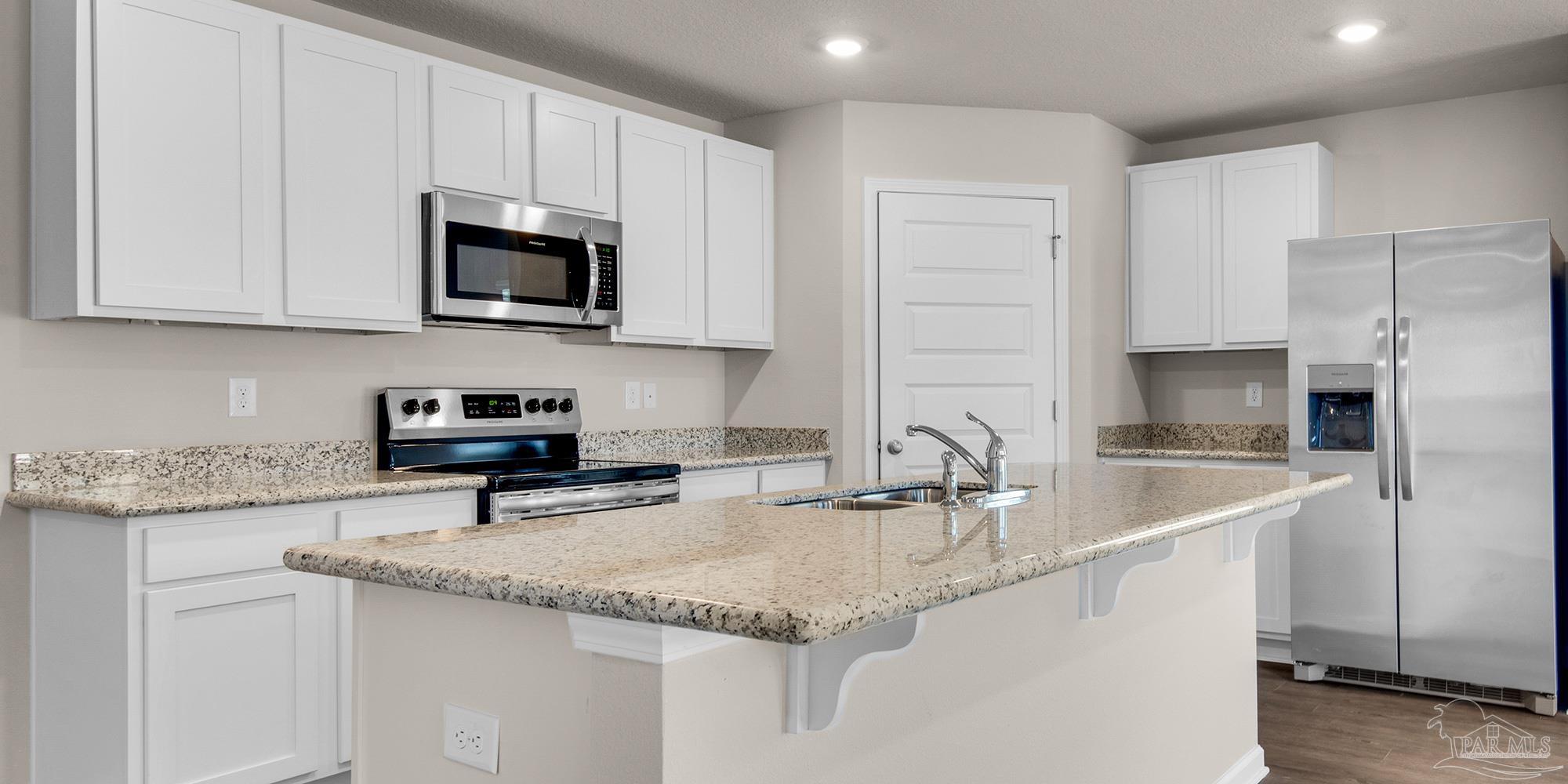 5213 Conservation Circle Pace, FL 32571 - Photo 2 of 13 a kitchen with stainless steel appliances granite countertop a sink a stove and a refrigerator