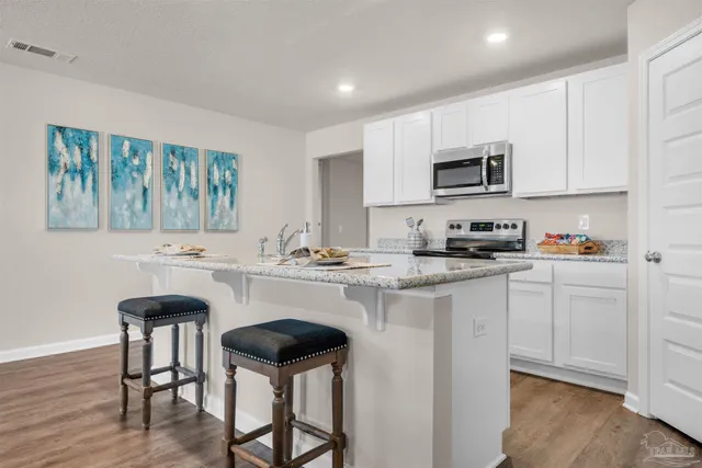 a kitchen with stainless steel appliances a sink stove and cabinets