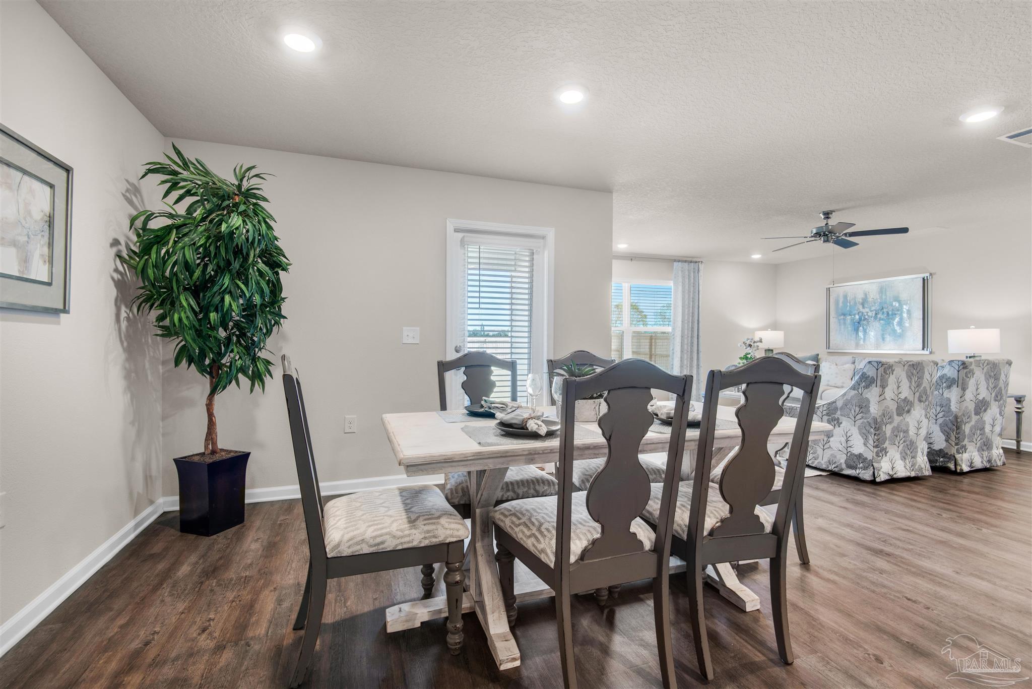 5213 Conservation Circle Pace, FL 32571 - Photo 5 of 13 a view of a dining room with furniture and wooden floor
