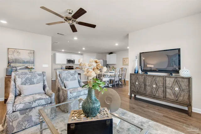 a living room with furniture and a flat screen tv