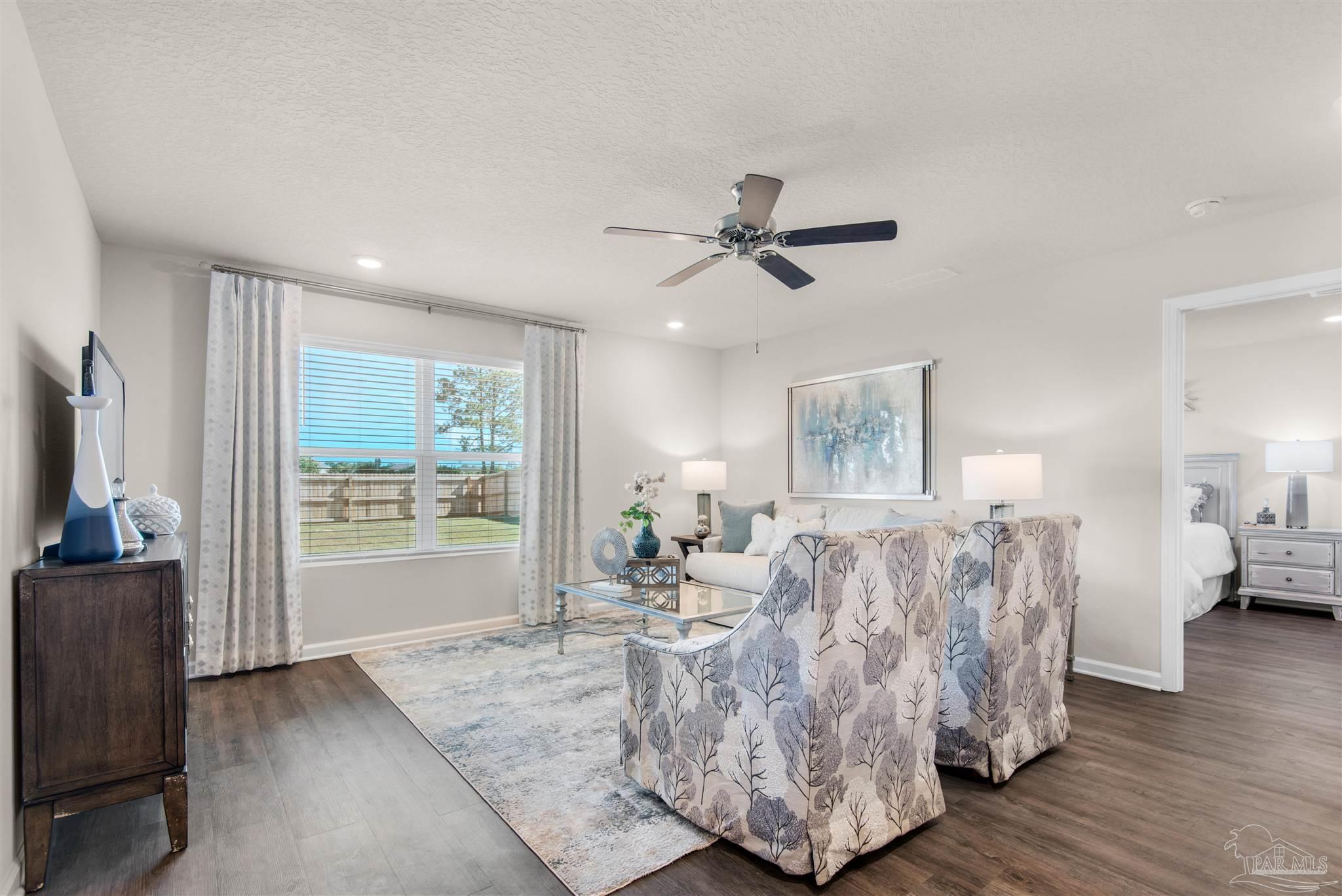 5213 Conservation Circle Pace, FL 32571 - Photo 7 of 13 a living room with furniture and a flat screen tv