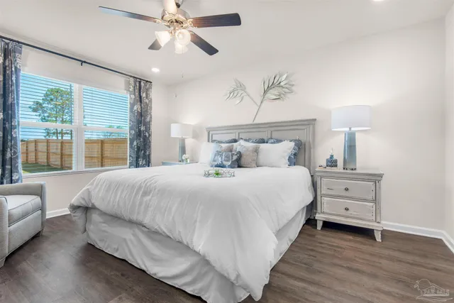 a spacious bedroom with a bed and a chandelier