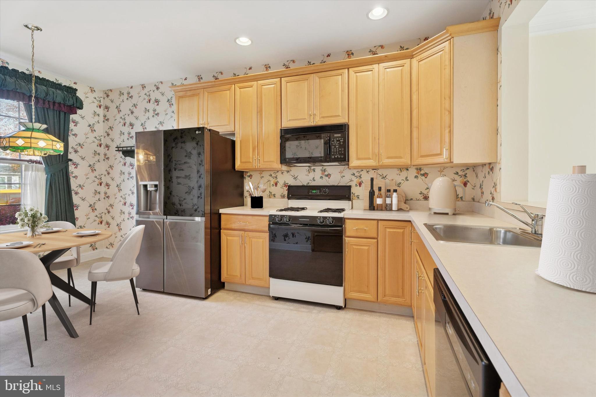 416 Ruth Court Harleysville, PA 19438 - Photo 11 of 35 a kitchen with stainless steel appliances a stove a sink refrigerator and a microwave