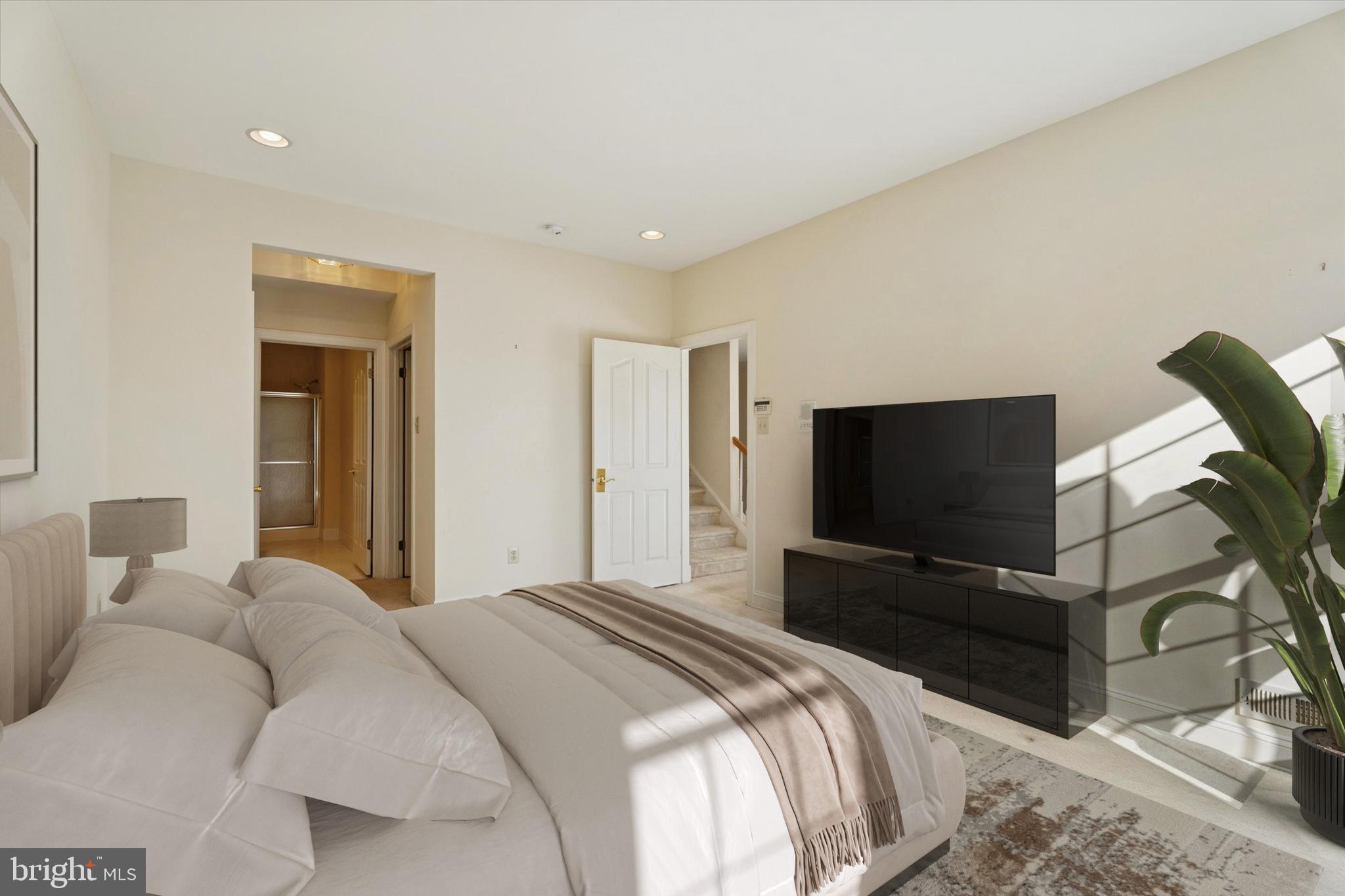 416 Ruth Court Harleysville, PA 19438 - Photo 20 of 35 a bedroom with a bed and a flat tv screen on wall