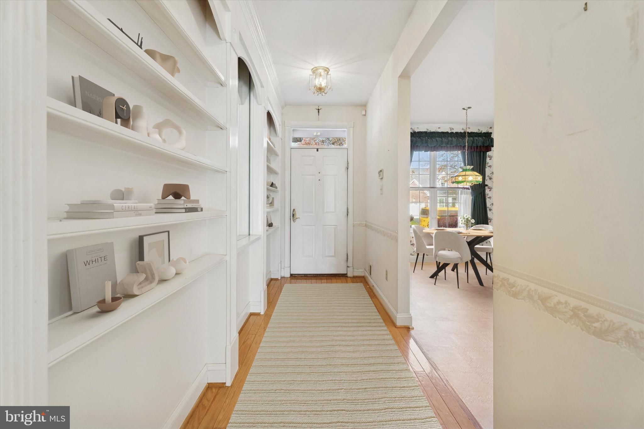 416 Ruth Court Harleysville, PA 19438 - Photo 3 of 35 a hallway with a white cabinets and wooden floor