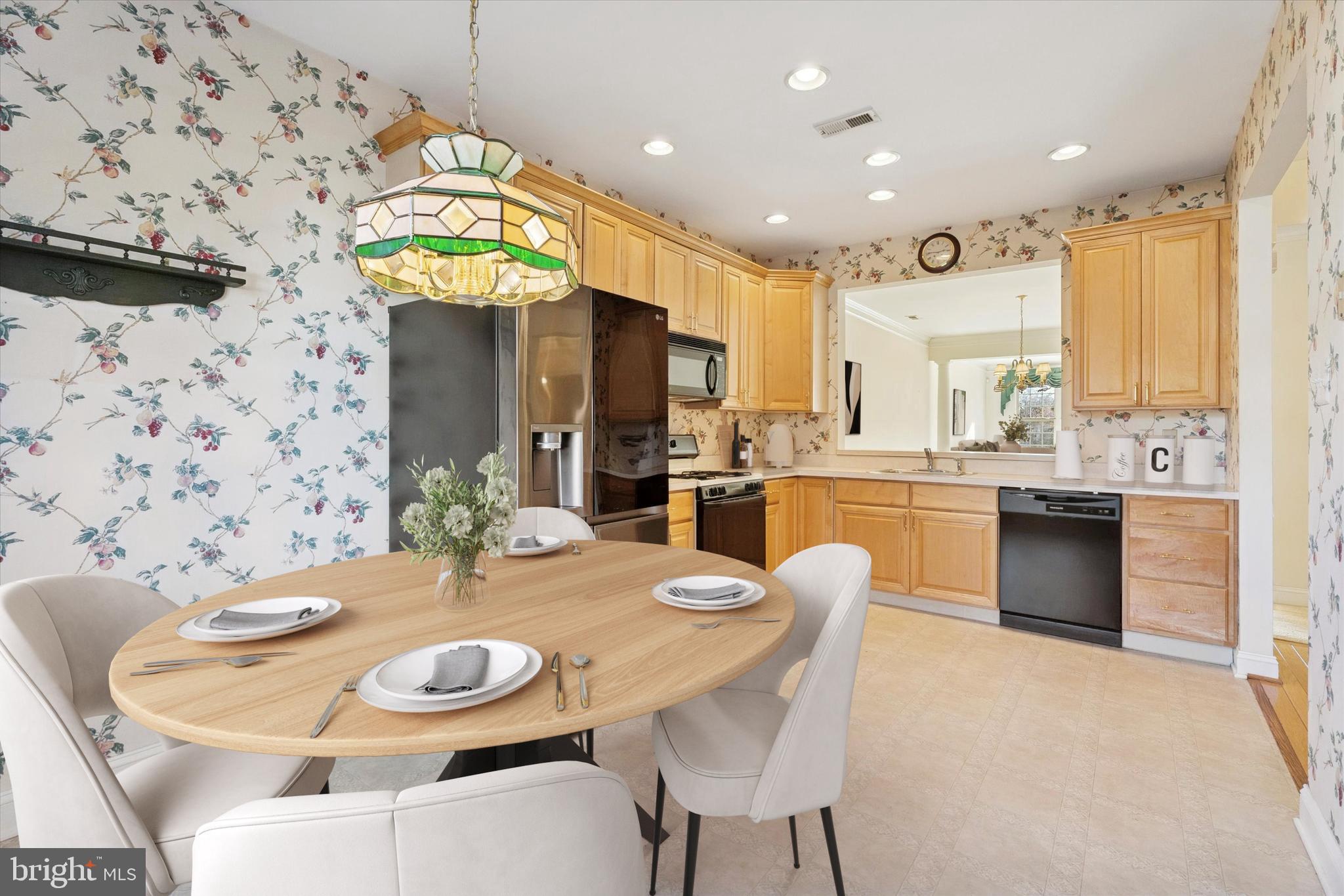 416 Ruth Court Harleysville, PA 19438 - Photo 9 of 35 a kitchen with stainless steel appliances kitchen island granite countertop a sink a stove a dining table and chairs