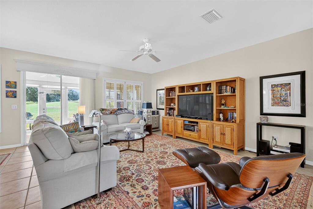 13536 Southeast 97th Terrace Road Summerfield, FL 34491 - Photo 11 of 34 a living room with furniture and a flat screen tv