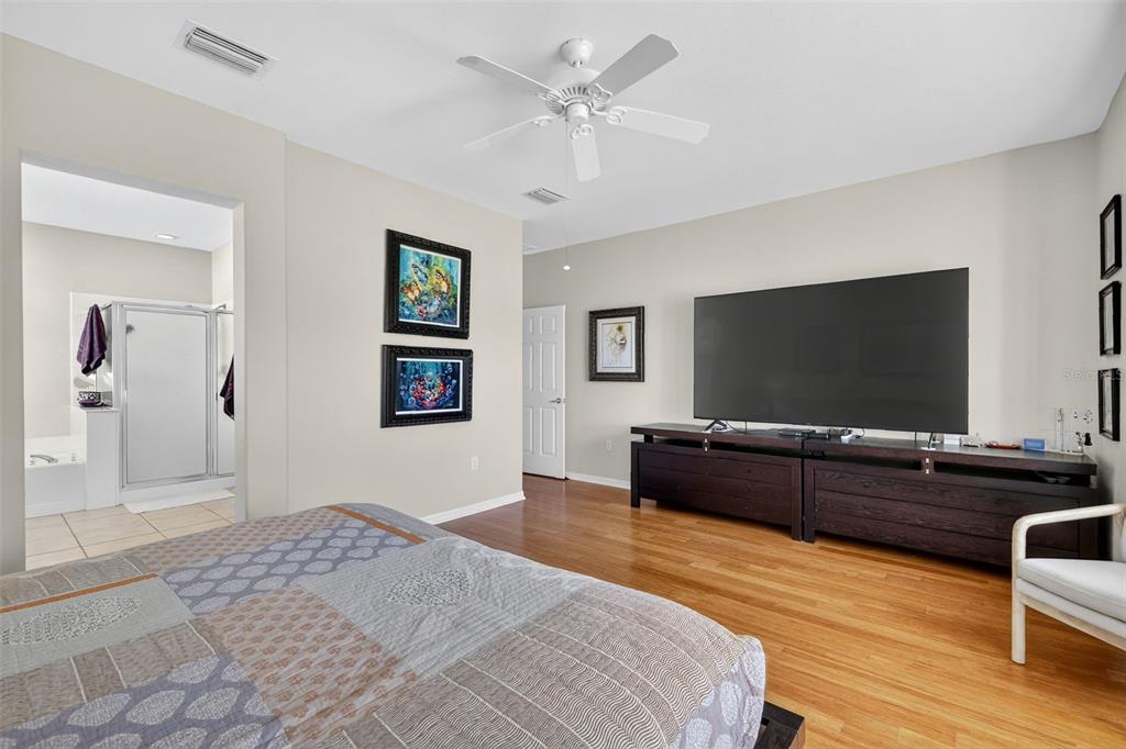 13536 Southeast 97th Terrace Road Summerfield, FL 34491 - Photo 16 of 34 a bedroom with a bed and a flat screen tv