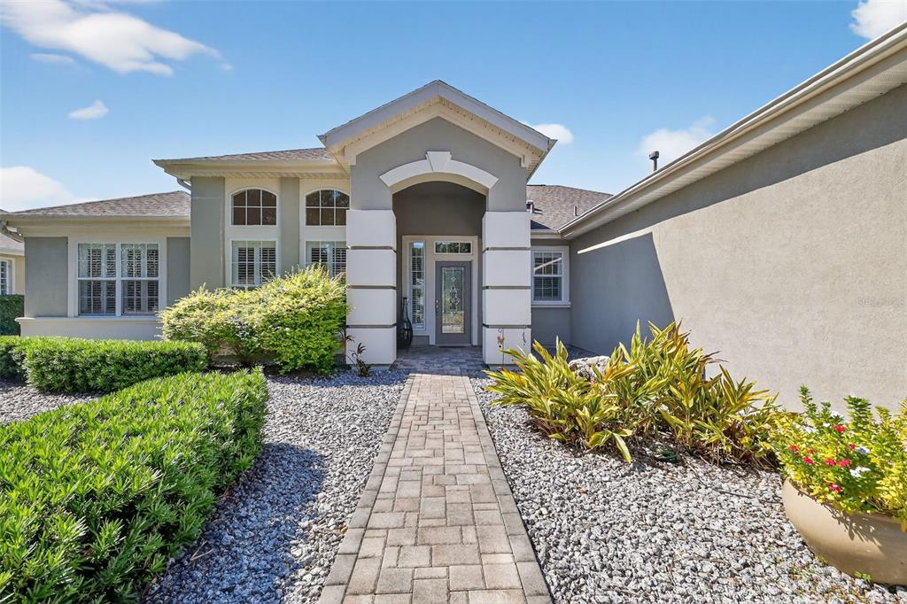 13536 Southeast 97th Terrace Road Summerfield, FL 34491 - Photo 2 of 34 a front view of a house with a yard