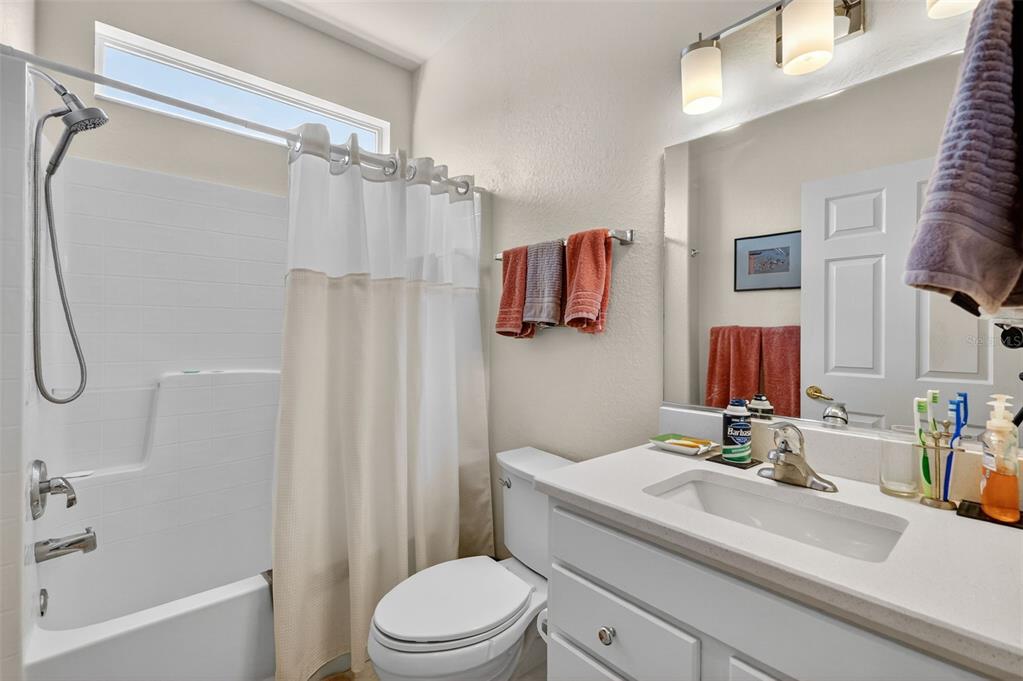13536 Southeast 97th Terrace Road Summerfield, FL 34491 - Photo 21 of 34 a bathroom with a sink a toilet and shower